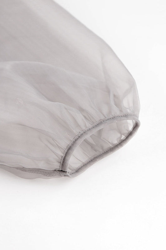 Elegante blusa lisa con cuello en V transparente y frenillo