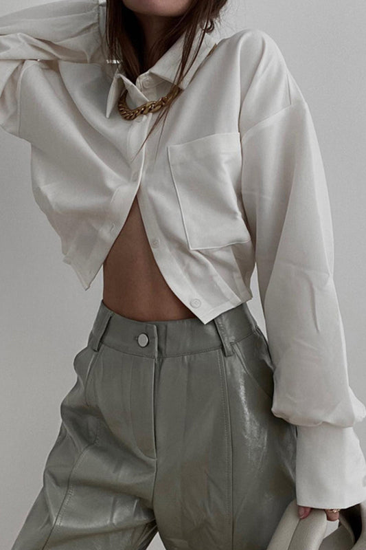 Elegante blusa lisa con cuello vuelto y bolsillos plegables