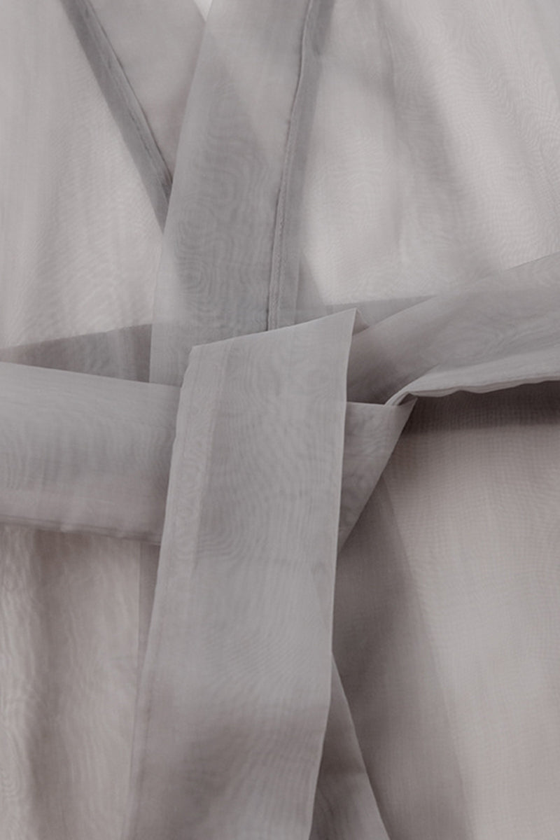 Elegante blusa lisa con cuello en V transparente y frenillo