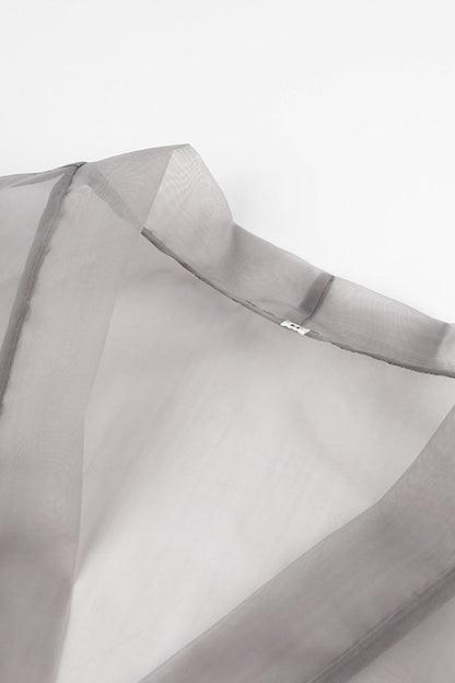 Elegante blusa lisa con cuello en V transparente y frenillo