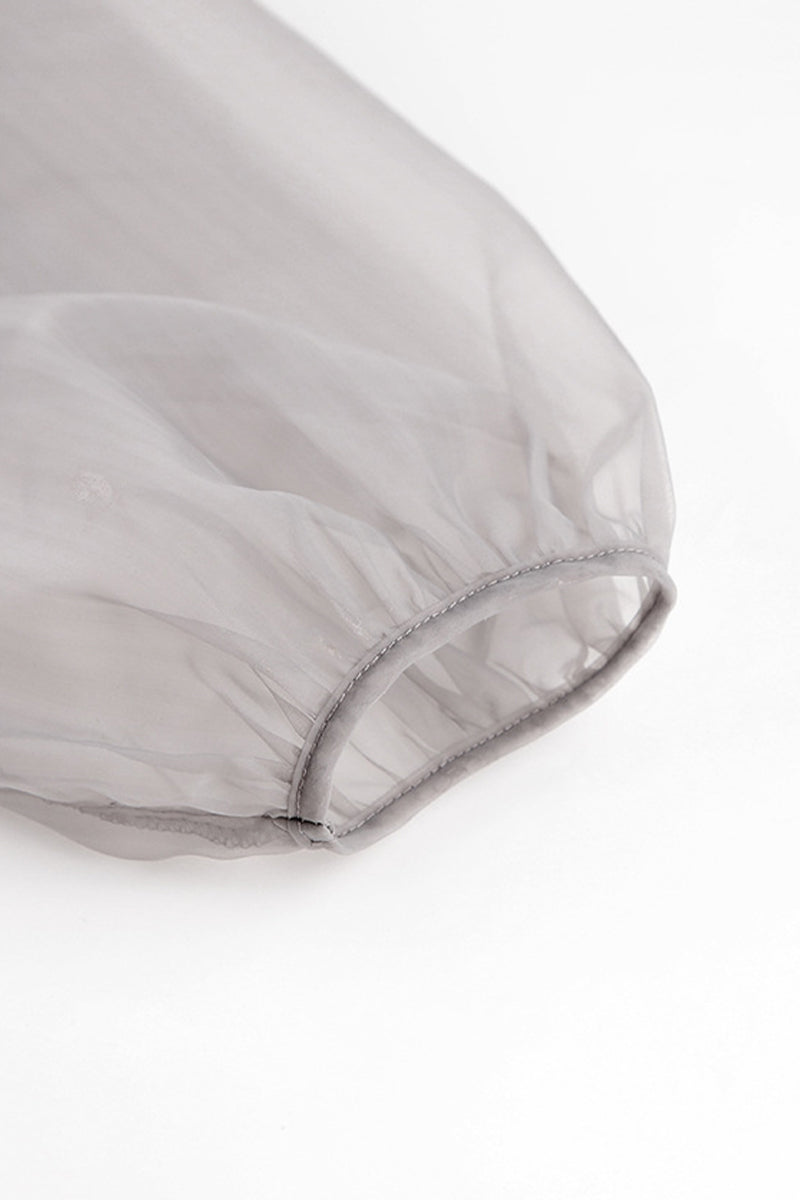 Elegante blusa lisa con cuello en V transparente y frenillo