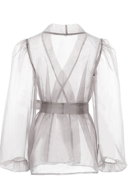 Elegante blusa lisa con cuello en V transparente y frenillo